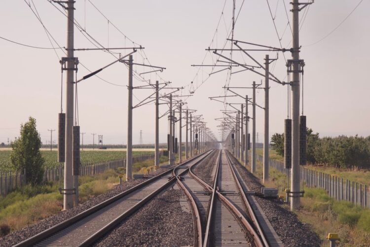 Rechte spoorlijn met bovenleiding die in de horizon verdwijnt